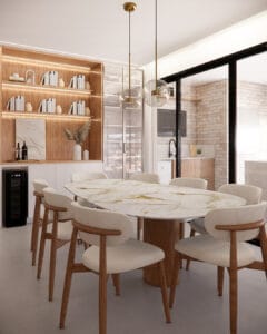 Sala de jantar planejada com mesa oval em mármore, cadeiras estofadas e estante iluminada em marcenaria amadeirada.